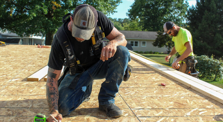 MDi builders performing measurements before putting up walls