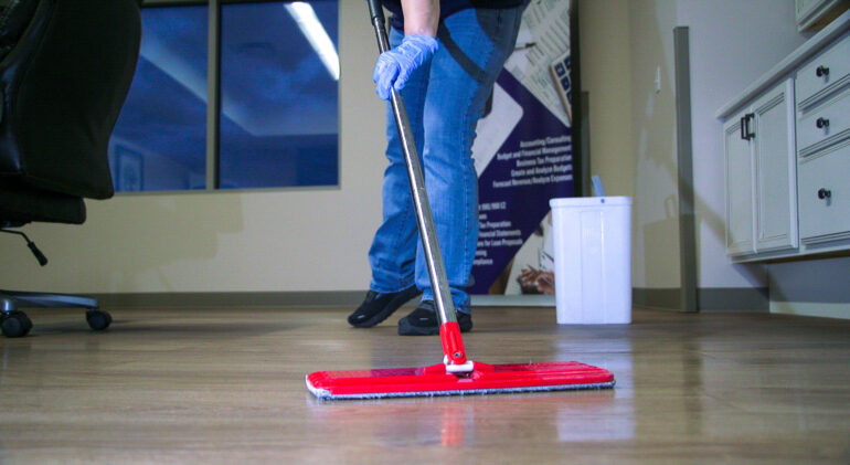 MDi employee cleaning fllor at client office location